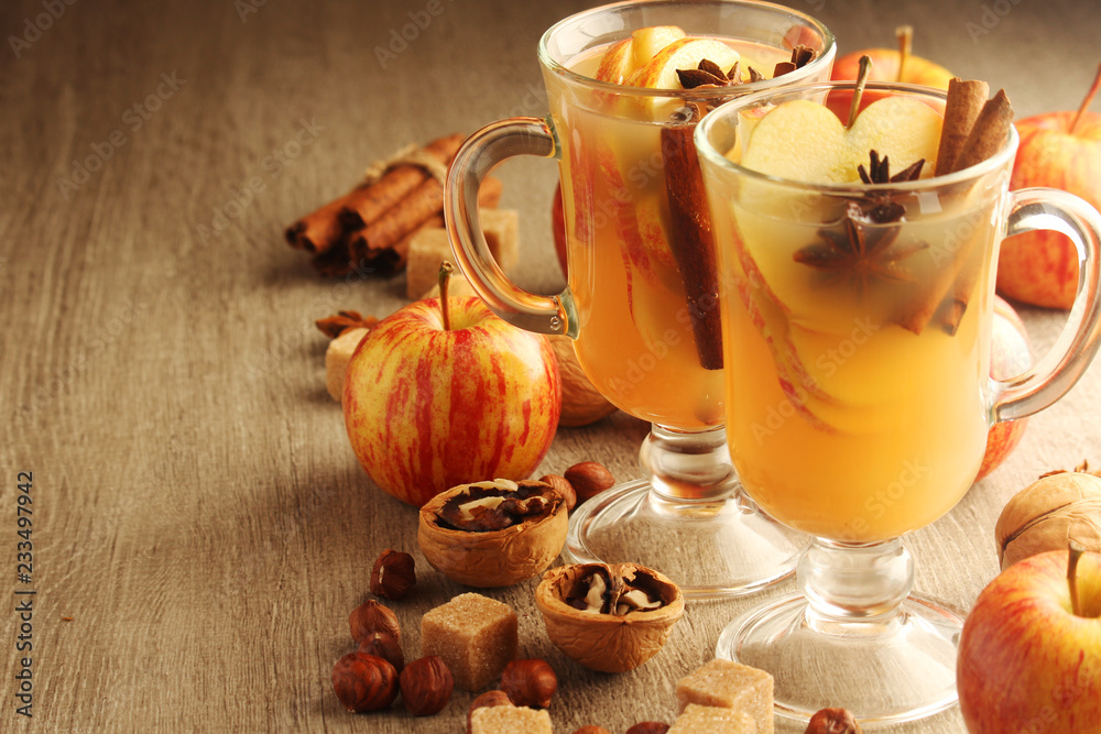 Two cups with hot cider in cold season with cinnamon and anise Two cups with hot cider in cold season with cinnamon and anise