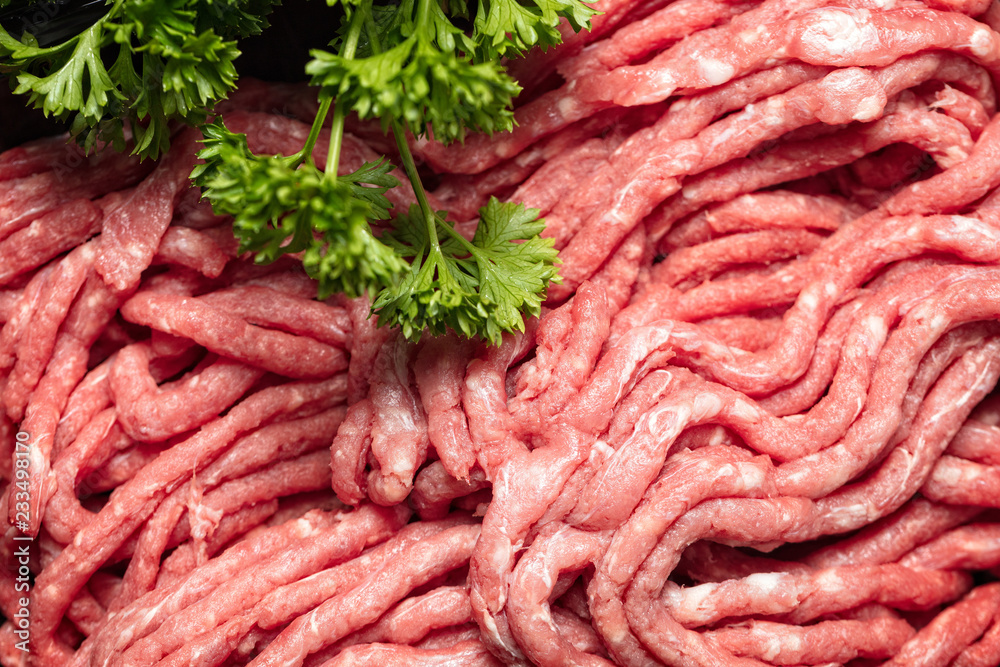 Background of Raw minced meat with parsley, close up Background of Raw minced meat with parsley, close up