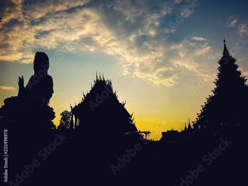 Guan Yin silhouette Statue with sunset at temple Wat hyua pla kang (Chinese temple) Chiang Rai, Asia Thailand, 