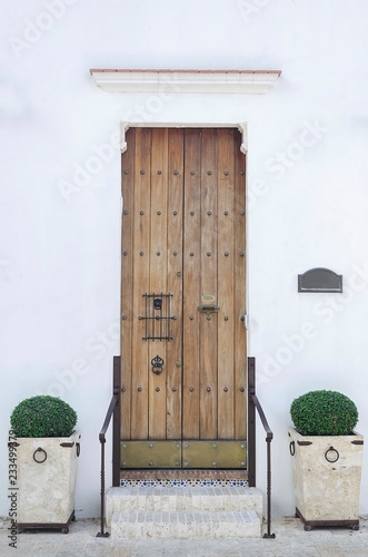 old white house and colonial door with stairs in colonial area