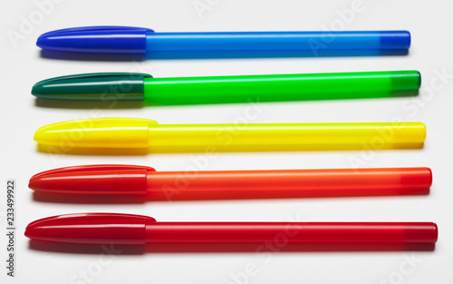 different colors pens isolated on the white background