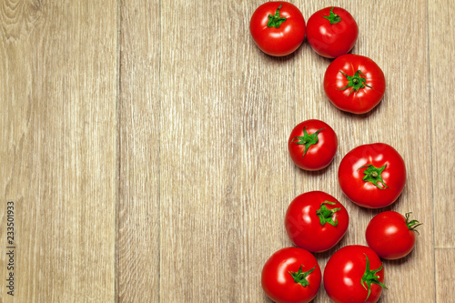 Fresh ripe tomatoes on a wooden background