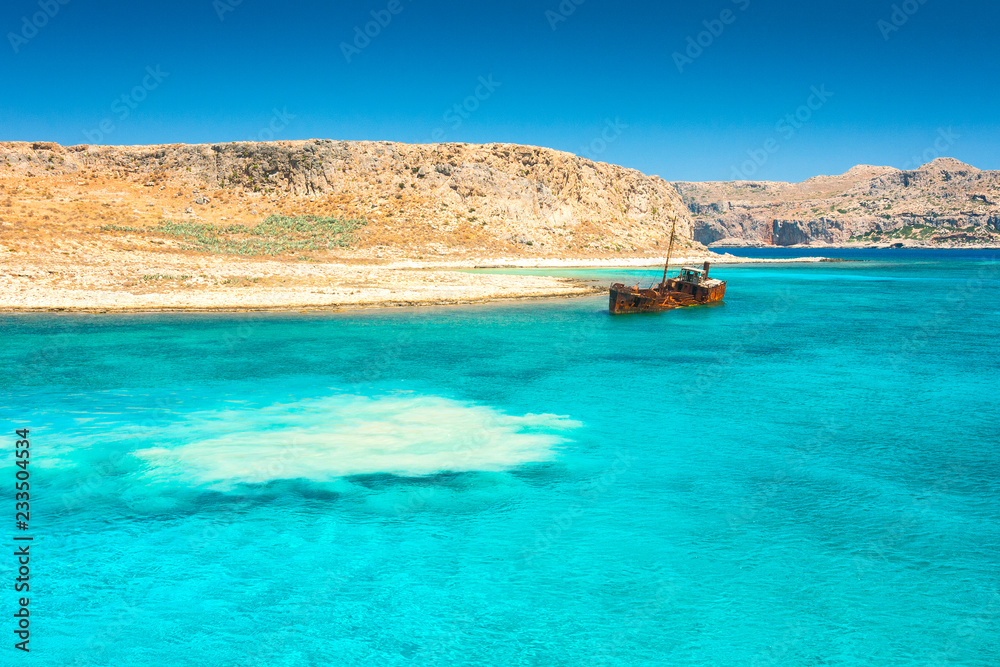 Rusting shipwreck at the seaside near The Balos lagoon at northwest from island of Crete, Greece.