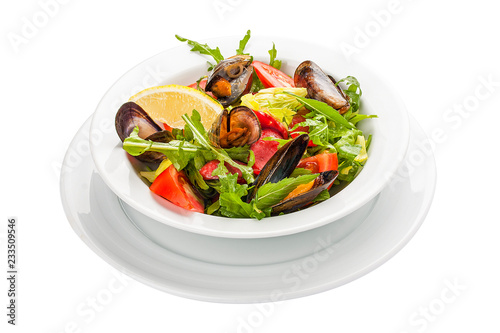 Salad with mussels and chorizo. A traditional Spanish dish. On a white background