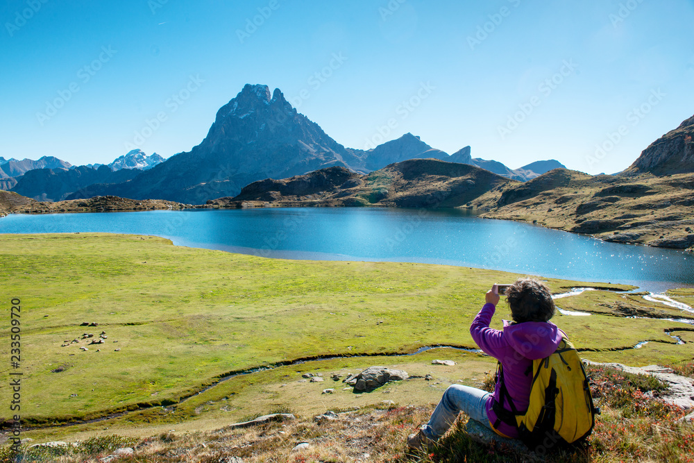 woman hiker taking picture from the Pic Ossau, France