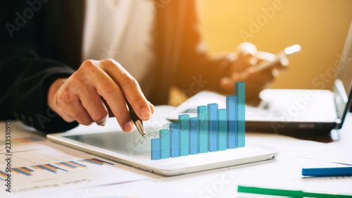 businessman investment consultant analyzing company financial report balance sheet statement working with digital graphs. Concept picture for stock market, office, tax,and project. 3D illustration. photo