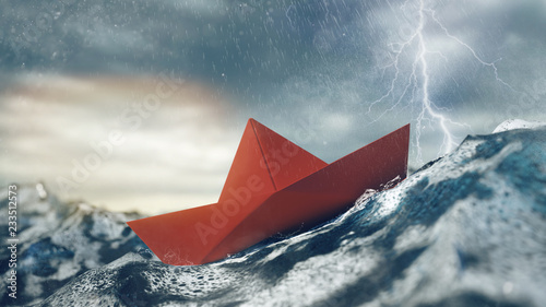Risiko Konzept mit Papierboot im Sturm auf Meer photo