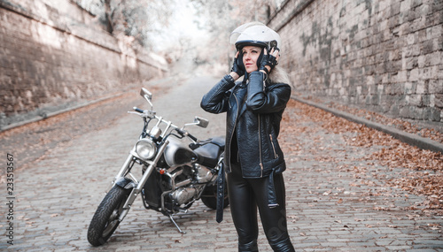 Beautiful biker woman with motorcycle. 