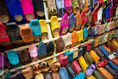 Colorful handmade leather slippers (babouches) on a market in Marrakech, Morocco © Khritthithat