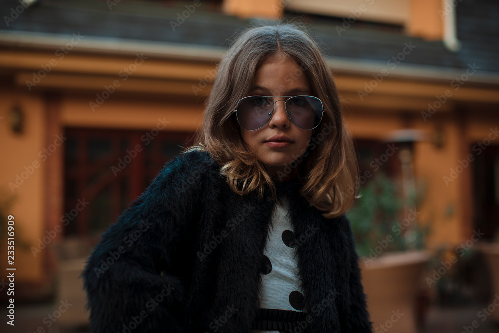 Girl in sunglasses. Posing on camera Girl in sunglasses. Posing on camera