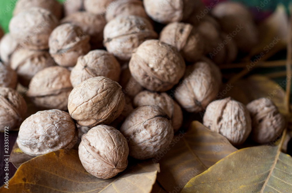 Walnuts with leaf on a wooden table. Walnuts with leaf on a wooden table.