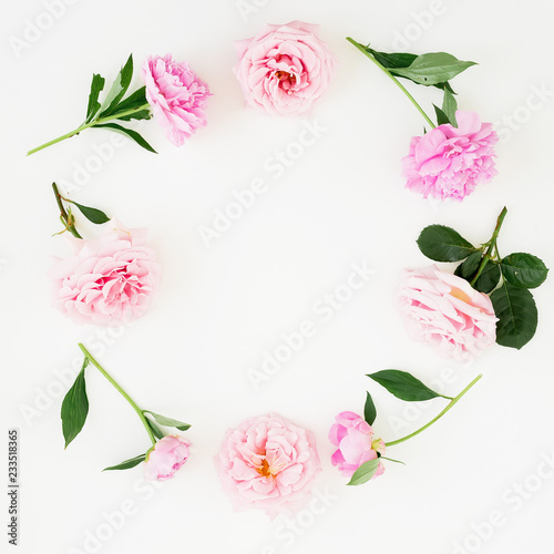 Fototapeta Naklejka Na Ścianę i Meble -  Floral frame of pink roses, peonies and green leaves on white background. Flat lay, top view. Flower background