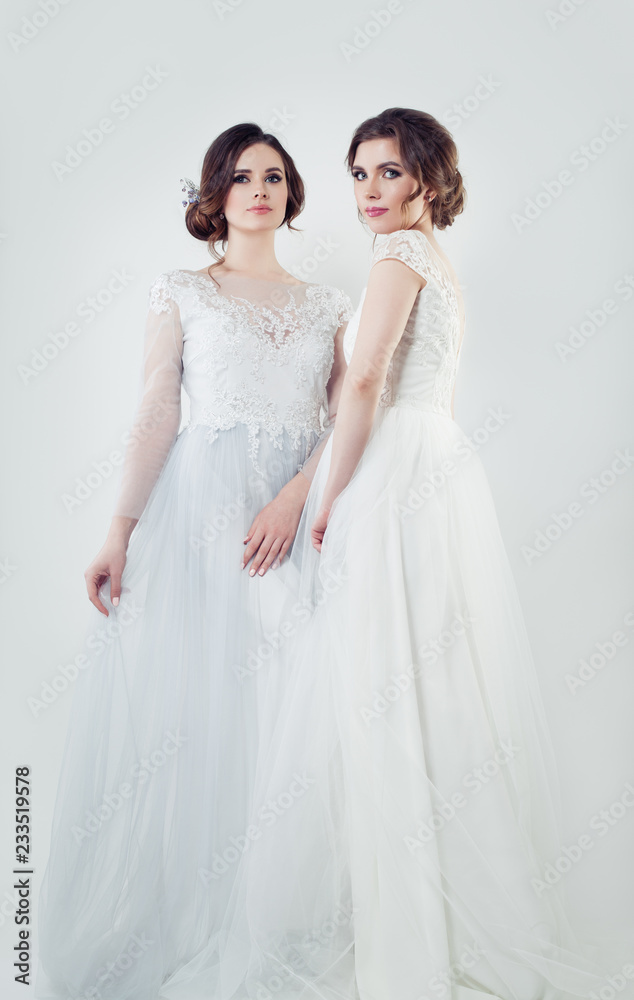 Two charming bride portrait. Perfect women in white wedding dress