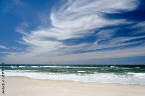 Landscape with a white sand beach and with a dark blue and white sky © DRStudio