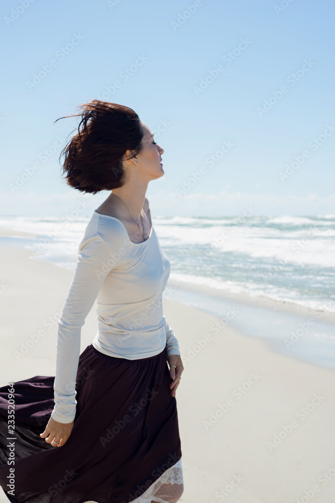 Beautiful brunette woman near the sea in motion Beautiful brunette woman near the sea in motion