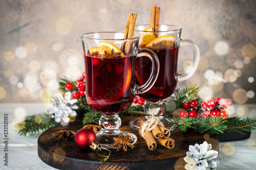 Mulled wine in glass mug with fruit and spices.