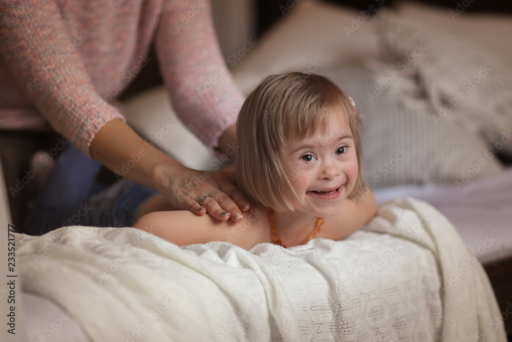 woman massage and gymnastics child Down syndrome woman massage and gymnastics child Down syndrome