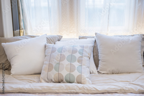 Set of clean pillows on luxury sofa in living room interior