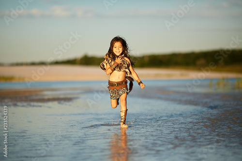 Fototapeta Naklejka Na Ścianę i Meble -  Girl runs along the shore