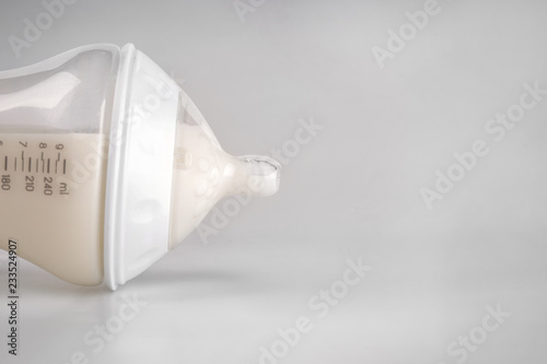 Closeup view of bottle of milk for baby on white background