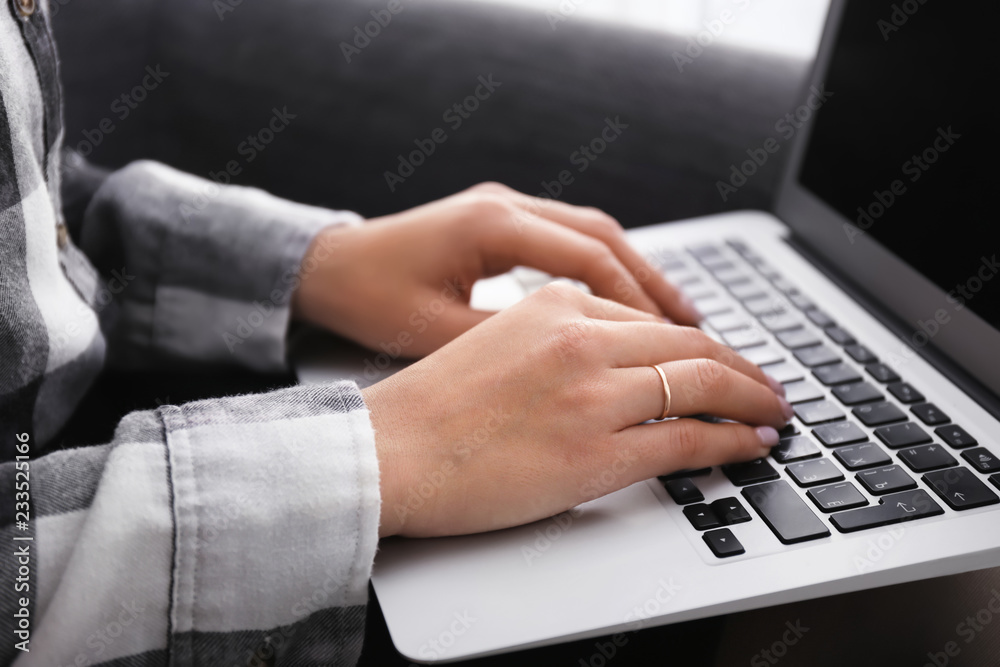 Woman with laptop sitting in armchair, closeup Woman with laptop sitting in armchair, closeup