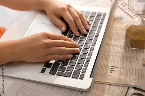 Woman using laptop on table...