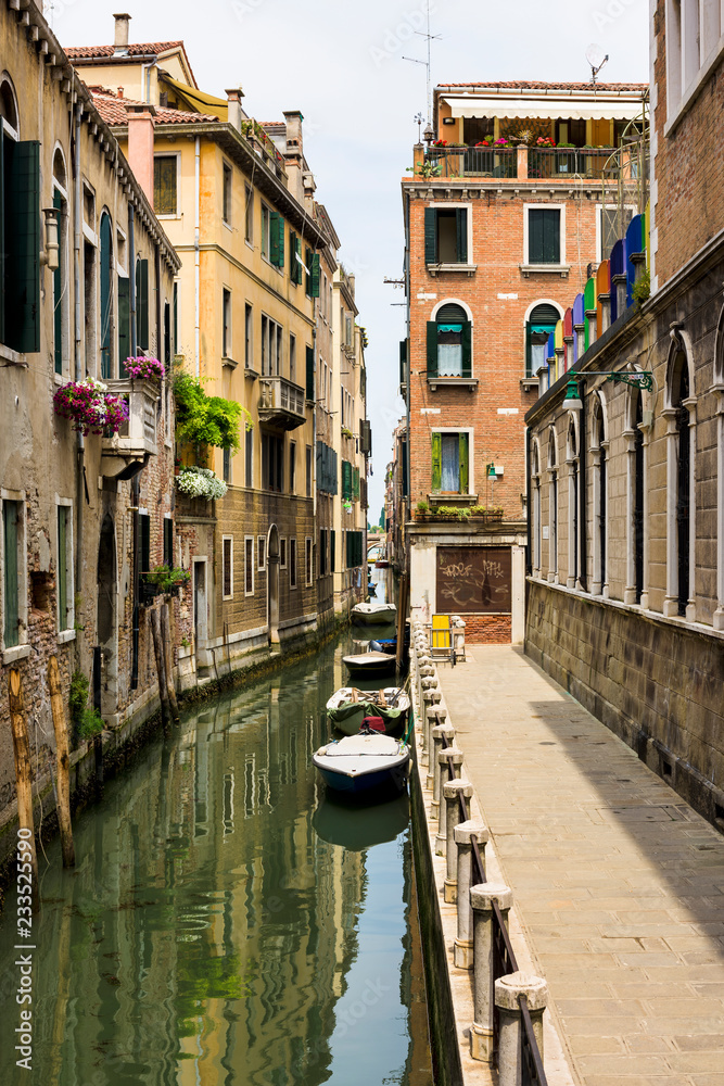 Venice in northern Italy is made up of 118 small islands separated by canals and bridges. This is just one of those canals with residential homes almost touching each other. 