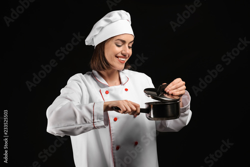 Young female chef with pot ...