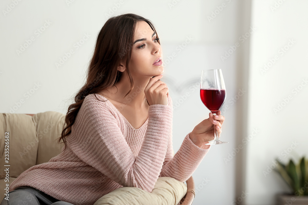 Beautiful young woman drinking wine at home Beautiful young woman drinking wine at home