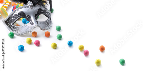 carnival mask among colorful confetti on white background