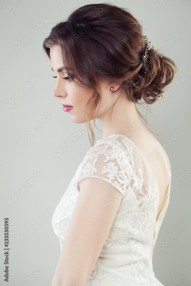 Wedding hair. Beautiful bride with makeup and bridal hairstyle, portrait