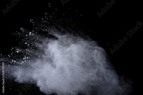 White powder explosion on black background. Dust splatted isolated. Paint Holi. © wooddy7