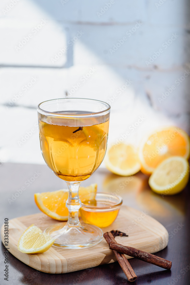 grog, mulled white wine on a white brick background with orange. close up. isolated. space