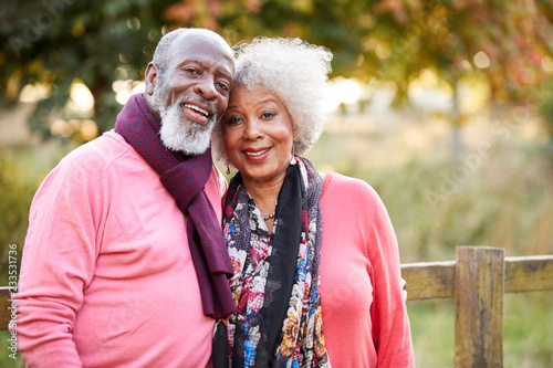 Portrait Of Senior Couple On Autumn Walk In Countryside Together