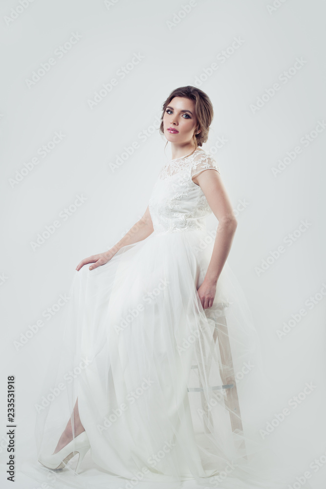 Beautiful woman with makeup and bridal hairstyle wearing white dress Beautiful woman with makeup and bridal hairstyle wearing white dress