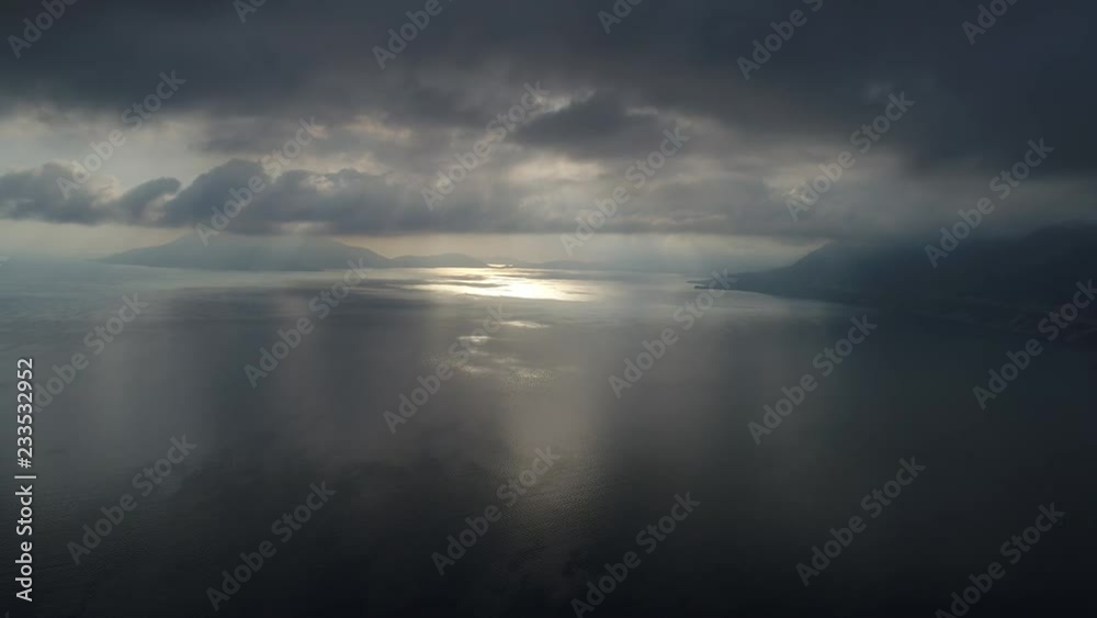 Aerial view. Dramatic view of the sea and sky at dawn.The camera moves above the water surface on high altitude. Beautiful seascape. Aerial view. Dramatic view of the sea and sky at dawn.The camera moves above the water surface on high altitude. Beautiful seascape.