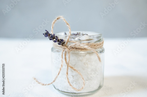 Natural herbal sea salt with aromatic lavender - perfect for relaxation. Cosmetic jars and bottles with salt, lavender flowers