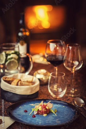 Tartare steak with a glass of wine and hornets  product photography for the restaurant  modern gastronomy