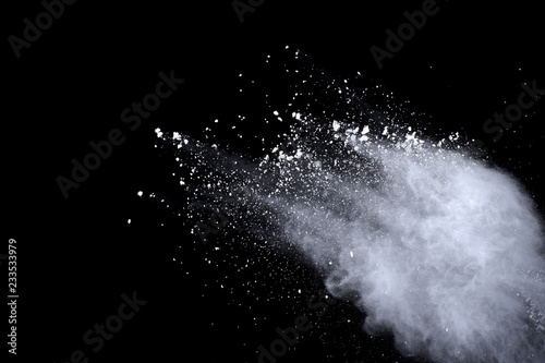 White powder explosion on black background. Dust splatted isolated. Paint Holi.