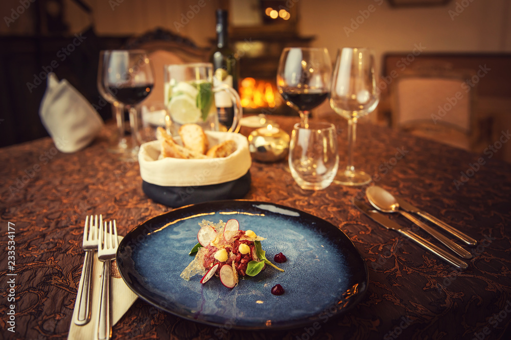 Tartare steak with a glass of wine and hornets, product photography for the restaurant, modern gastronomy Tartare steak with a glass of wine and hornets, product photography for the restaurant, modern gastronomy