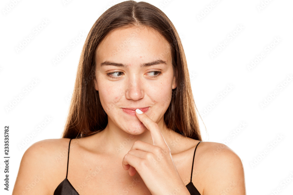 Naklejka premium Portrait of smiling thoughtful woman on white background