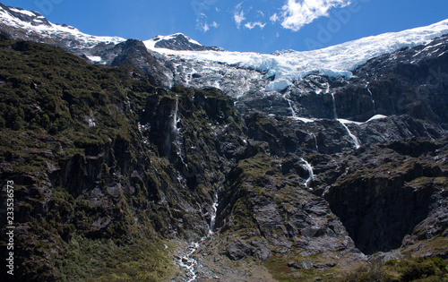 Rob Roy Glacier with waterfalls made of melting water in New Zealand