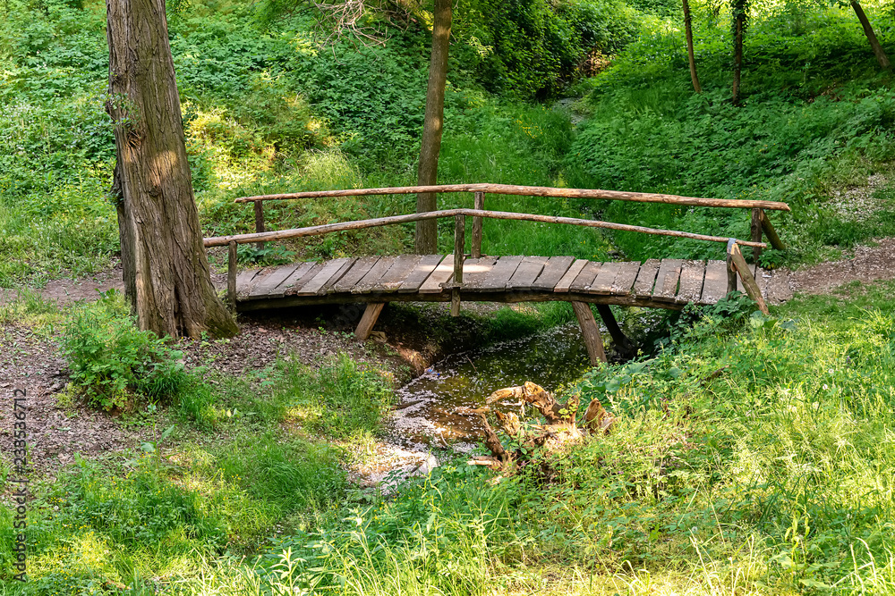 Fototapeta premium Top view wooden bridge over small river