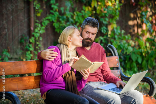 Share or exchange information knowledge. Man and woman use different information storage. Couple spend leisure reading. Information source concept. Couple with book and laptop search information