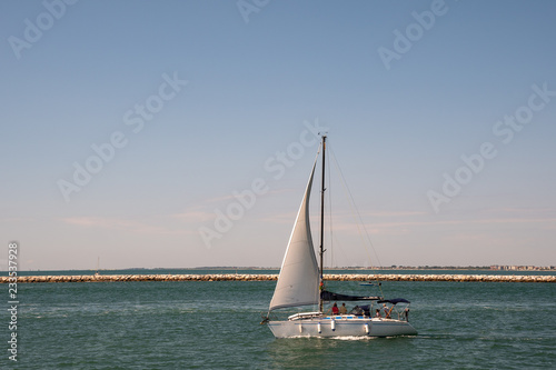 Sailboat on the Adriatic Sea with blue sky in summer, Veneto, Italy
