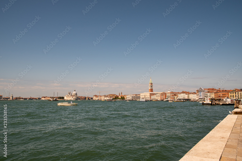 View of Venice with boats and blue sky in summer, Veneto, Italy