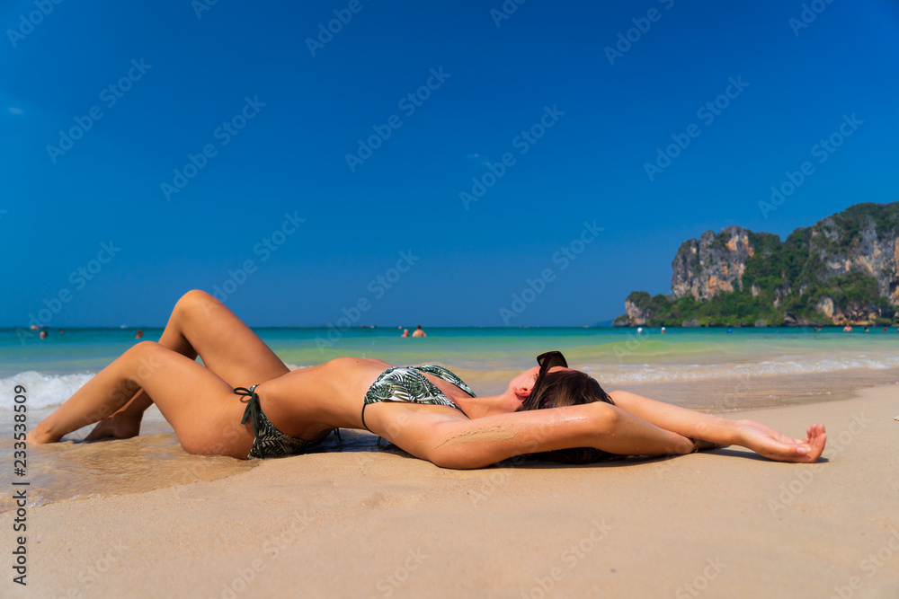 Cute woman relaxing on the summer beach. Cute woman relaxing on the summer beach.