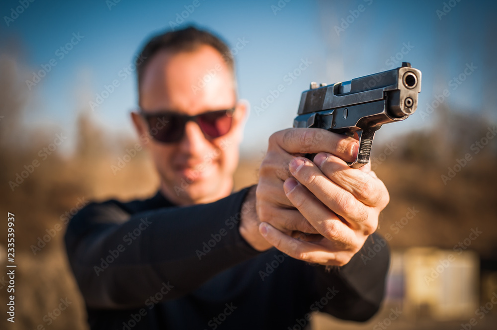 Police agent bodyguard gun pointing pistol to attacker. Front view Police agent bodyguard gun pointing pistol to attacker. Front view