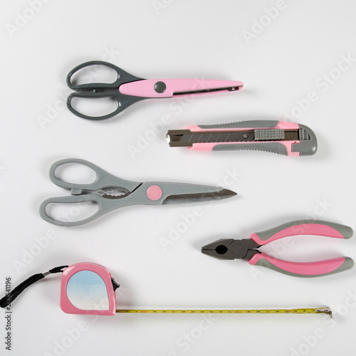 Pink feminine handy tools on a white background