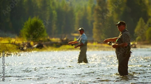 Canadian males fly fishing in competition on freshwater river